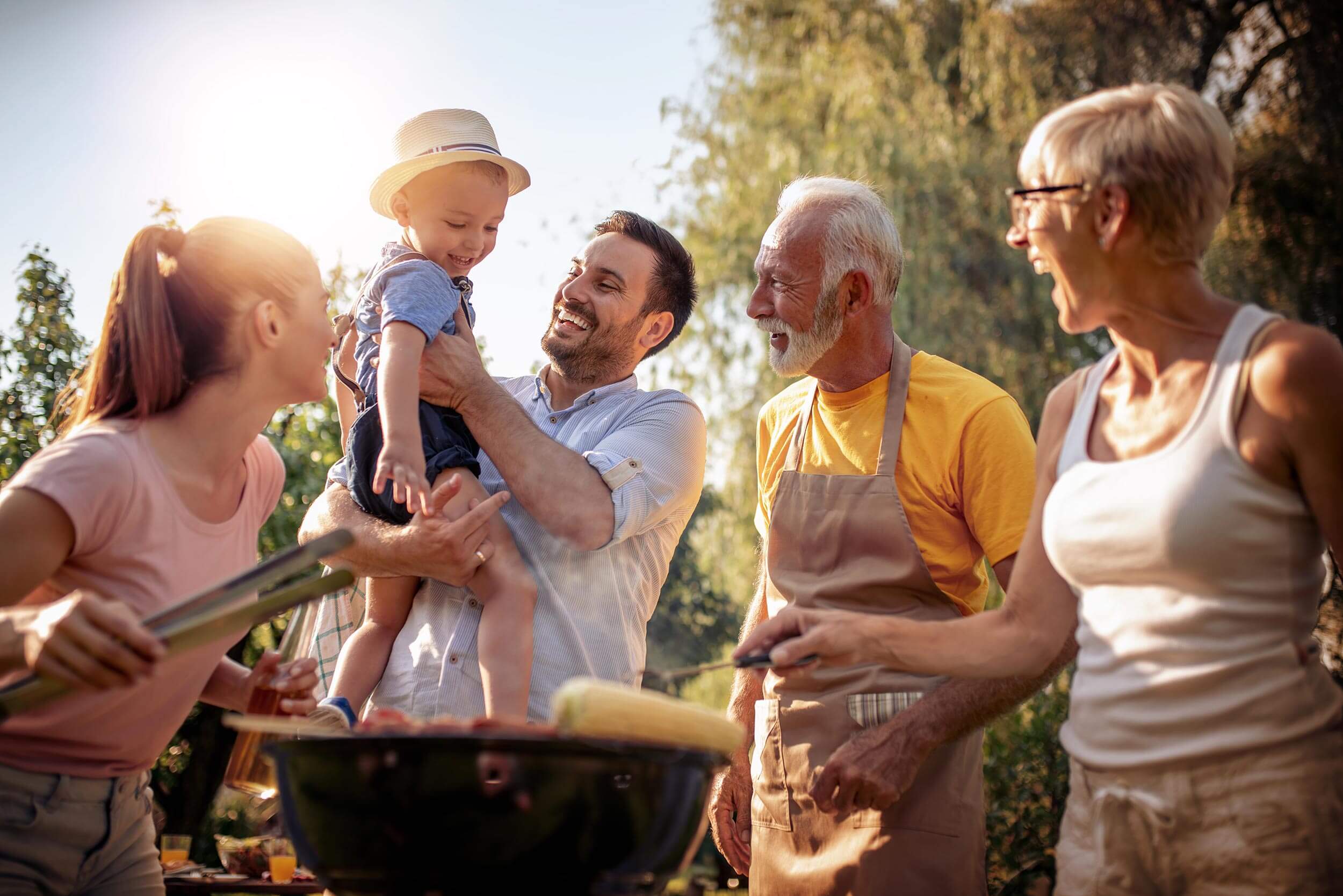 Multigenerational family enjoying a backyard family barbecue 