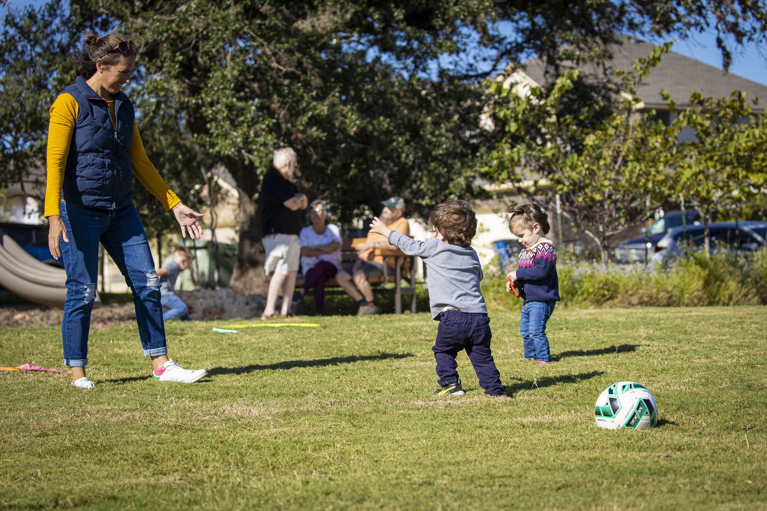 Young children playing soccer at Veramendi pocket park